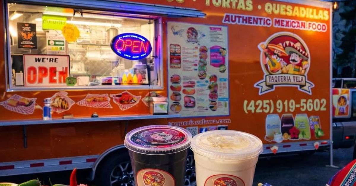 The Taquería Vela food truck with its service window open and the Taquería Vela logo on the side